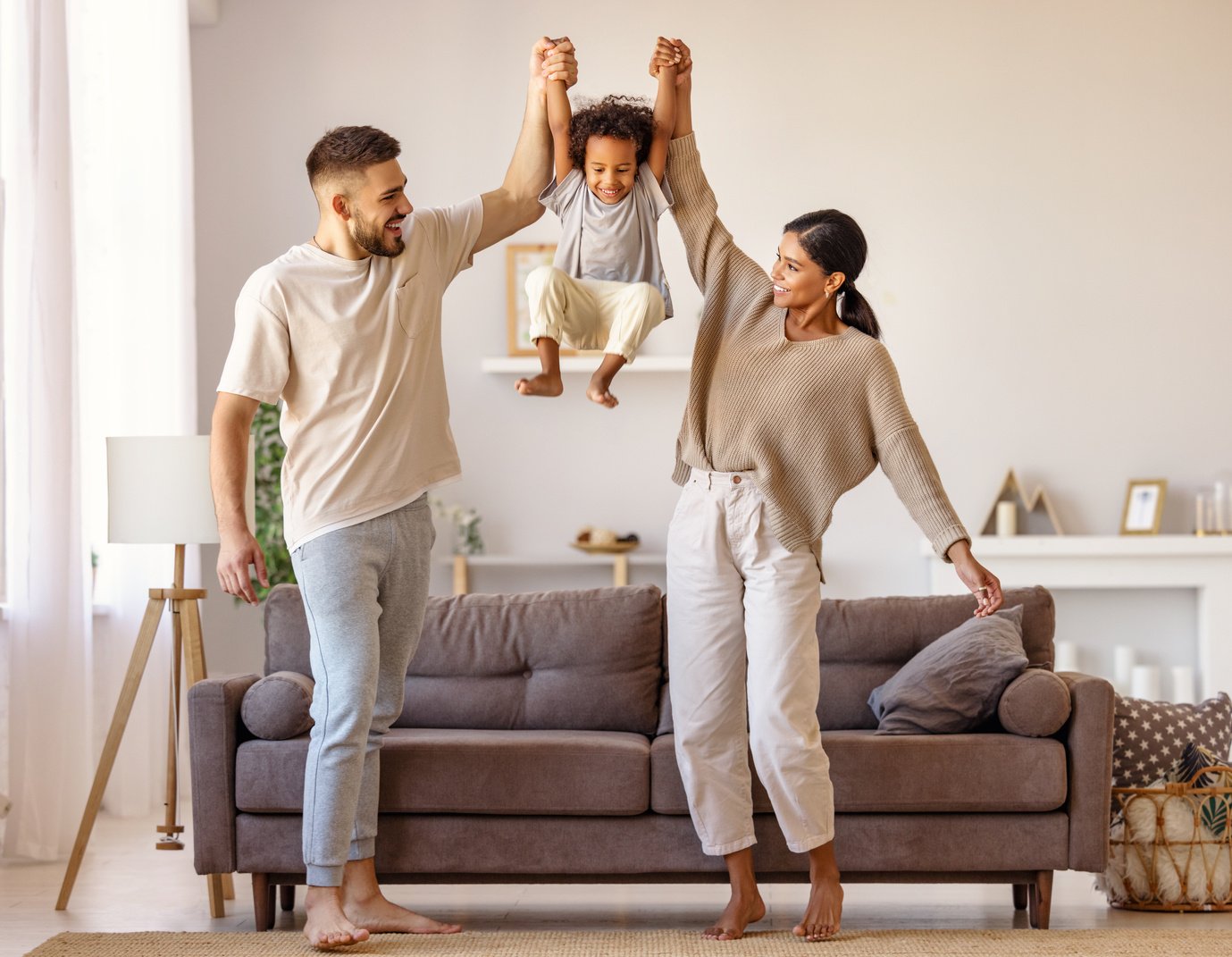 Diverse family playing near sofa