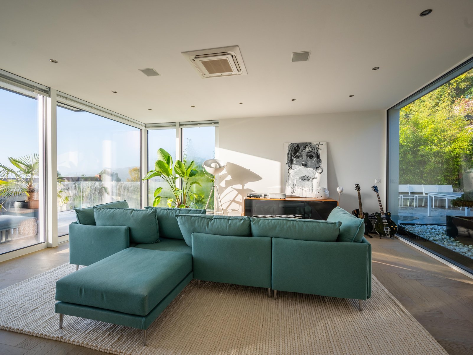 Green Couch Beside Green Potted Plant